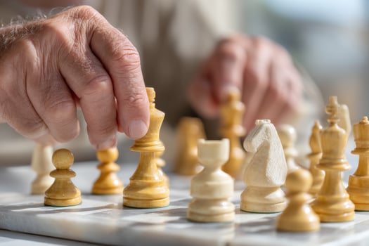 Two hands playing chess on marble chessboard, focusing on strategic moves photo
