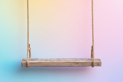 Wooden swing on colorful background photo