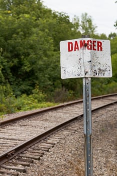 Old Warning Sign Along Railway Tracks photo