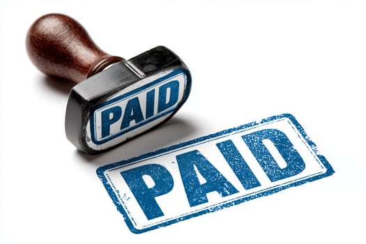 Grunge blue ink rubber stamp with paid sign on white background for financial documentation purposes photo