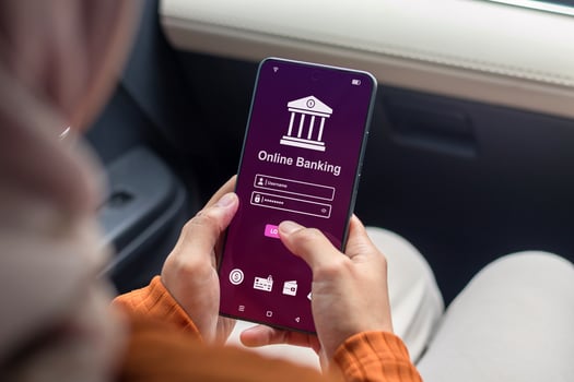 A woman using smartphone to access online mobile banking. Enter username and password to access mobile banking. photo