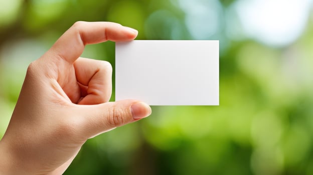 Hand holding blank business card photo