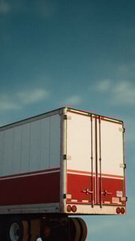 A truck is driving on a road photo