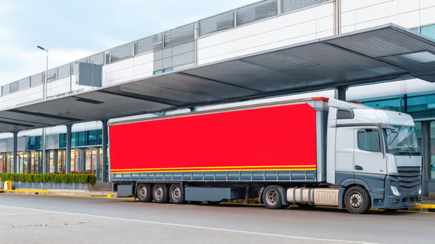 A large truck with a red banner on the side of it photo
