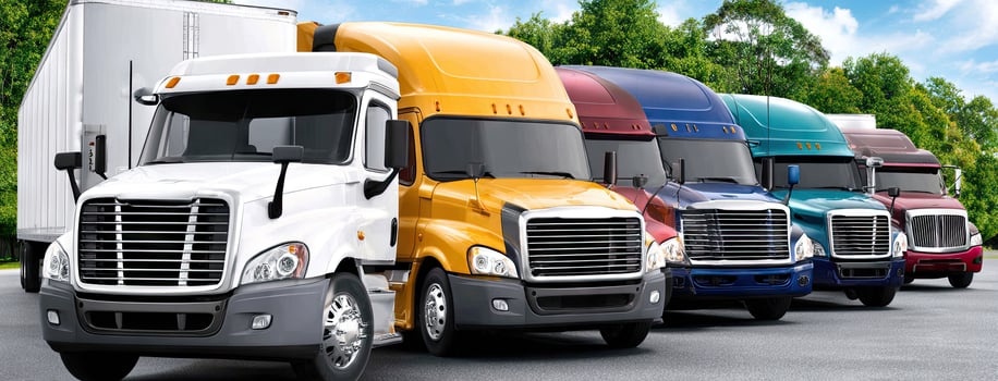 A row of semi trucks lined up in a row photo