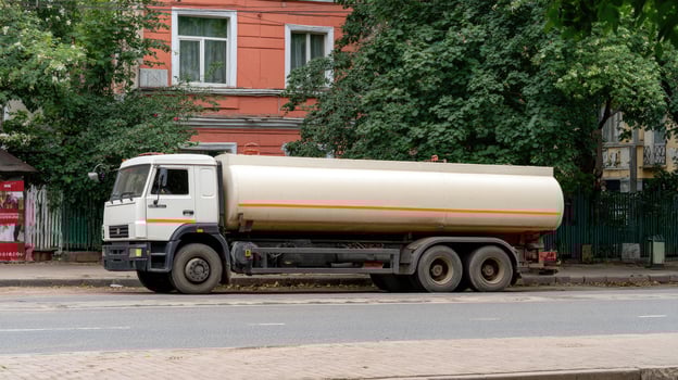A tanker truck is parked on the side of the road photo