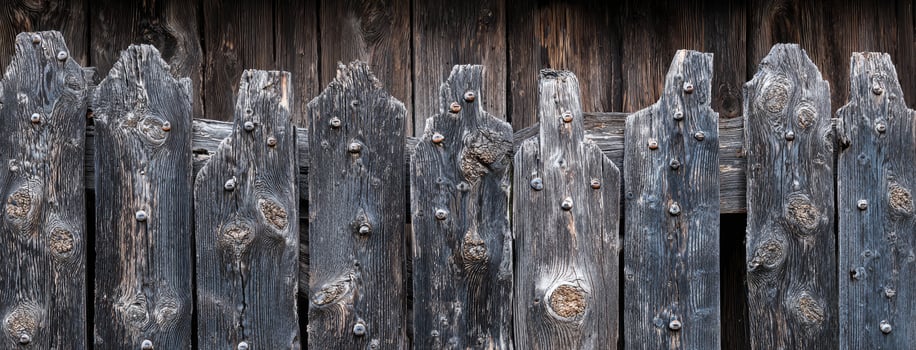 A close up of a wooden fence with a bird on it photo
