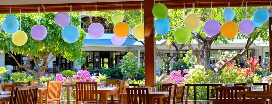A restaurant with colorful balloons hanging from the ceiling photo