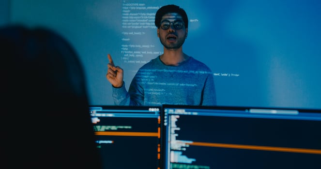 Group Asia male software developers mentor leader manager talk strategy plan to executive write prompt AI bot IT app program nomad, game, designer, data center. Projecting slideshow code photo