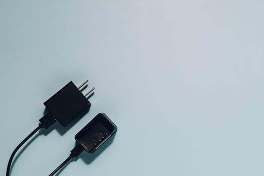 Black Charger and Plug on Blue, Power and Connectivity Concept photo