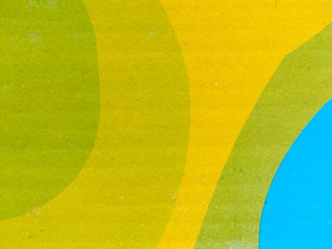 Abstract Overlapping Shapes in Green, Yellow, and Blue on Smooth Background photo