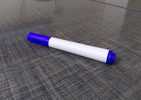 Blue and White Marker with Cap on Textured Surface in Stationery Context photo