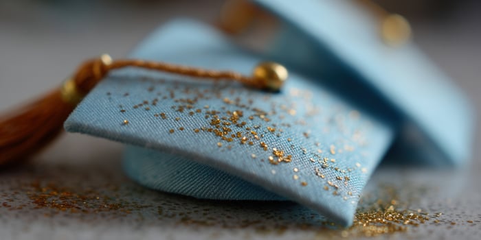Miniature graduation caps sprinkled with golden glitter, celebrating achievement and success. photo