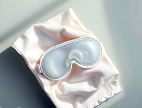 A white eye mask on a white cloth photo