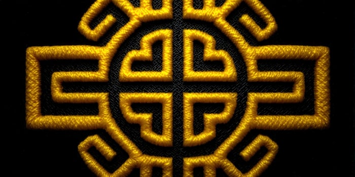 Intricate golden embroidery detail, showing a beautiful, elegant design on a black backdrop. photo