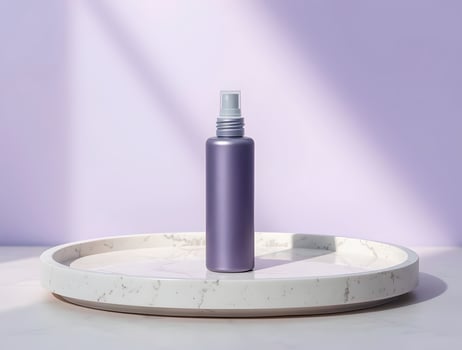 A bottle of hair spray on a marble tray photo