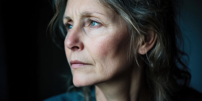 A thoughtful woman gazes out the window, lost in contemplation, showcasing her beauty photo