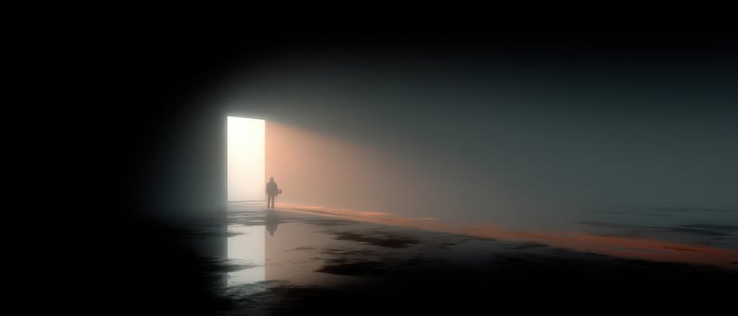 Person walking toward light in a dark space photo