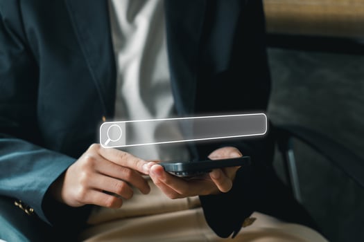 A business professional using a smartphone to explore SEO strategies and digital marketing in a modern office environment. photo