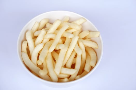 Crispy potato sticks served in a simple white cup. Popular crunchy snack loved by kids and adults alike. Perfect as a fun, flavorful treat for any time of day-light, salty, and irresistibly delicious photo
