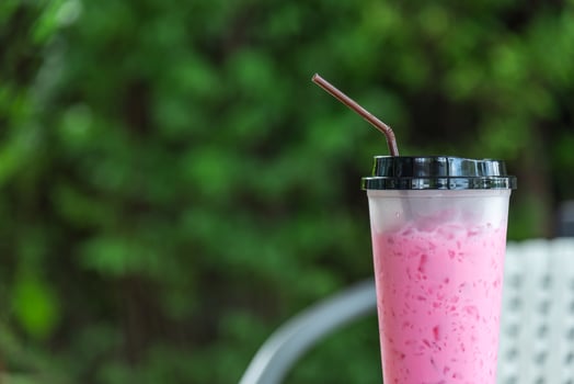 Thai style iced pink sweet milk in coffee shop photo