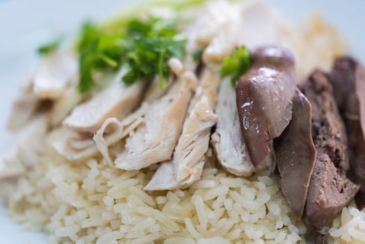 A plate of rice and meat with a side of vegetables photo