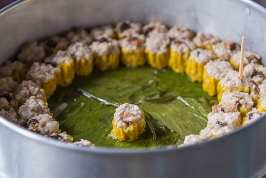 A pan filled with food and a stick photo