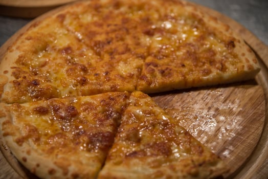 A pizza on a wooden plate photo