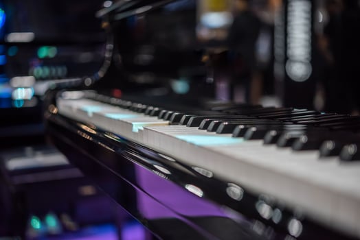 A close up of a piano with purple lights photo