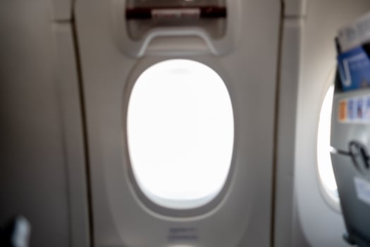 View From an Airplane Window During a Flight, Showcasing a Bright Sky With No Visible Landmarks photo