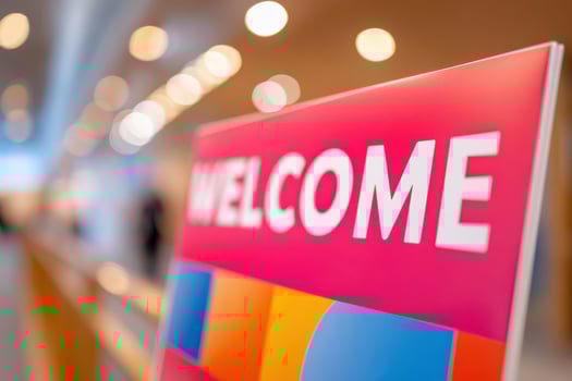 Welcome signage at a hybrid event showing hospitality and inclusivity photo