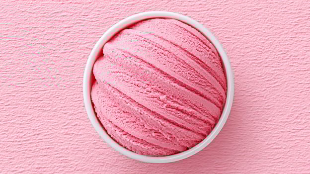 Delicious pink ice cream served in a round white bowl on a textured pink background, perfect for summer treats or dessert celebrations photo