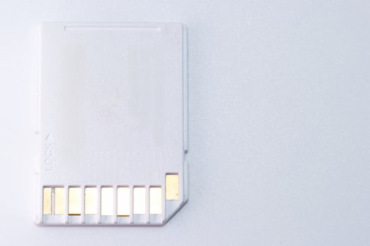 Memory card on a light background used for data storage in electronic devices like cameras and computers photo