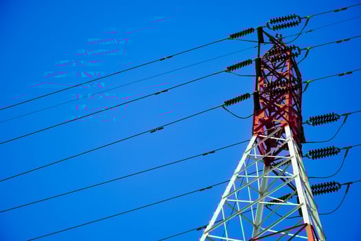 High-voltage electric poles are made of steel structures painted white and red colors. photo