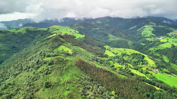 Aerial View of a Beautiful and Lush Green Mountain Landscape Surrounded by Cloudy Weather photo