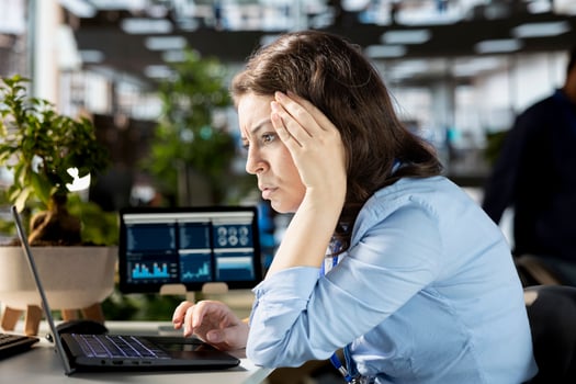 Frustrated irritated businesswoman struggling with tasks completion at the office, working hard and in tension to deal with a mistake or business failure. Upset employee with burnout. photo