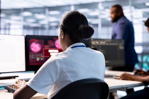 Server farm IT professional trying to protect hardware from hacker attack stealing info. Woman in data center trying to get rid of virus after seeing security breach alert on display photo