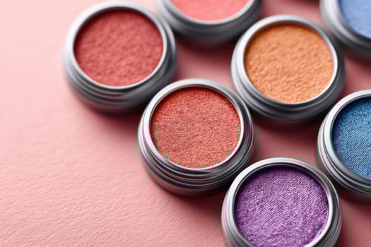 Close-up of vibrant eyeshadow bases in sleek packaging showcasing rich colors photo