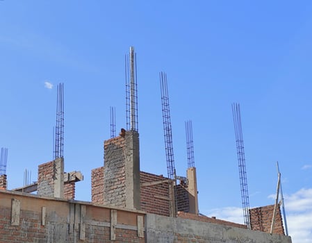 Unfinished House Construction under Clear Blue Sky photo
