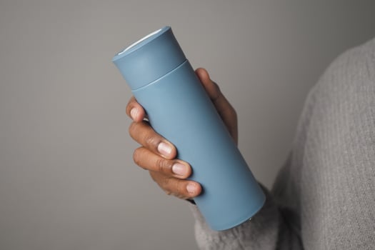 Reusable Water Bottle held in a person hand indoors photo