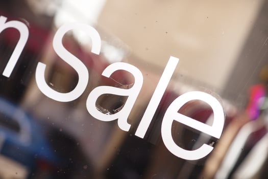 Clothing on sale at a storefront display window photo