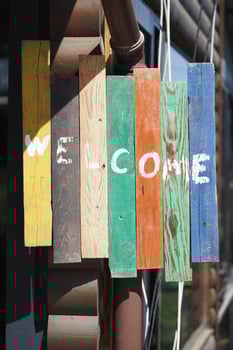 Colorful wooden welcome sign at a rustic location photo