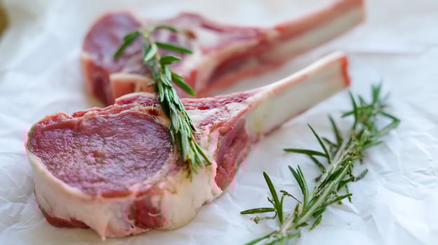 Raw Lamb Chops with Fresh Rosemary Ready for Cooking. photo