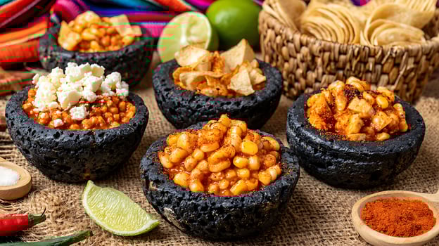 Delicious Mexican Frijoles and Chips Presented in Traditional Molcajete Bowls. photo