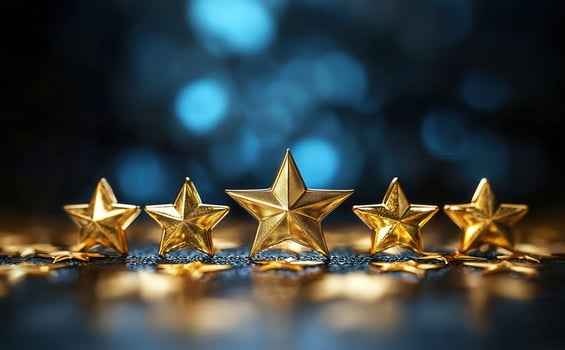 Five golden stars shimmering on a bed of glitter, symbolizing quality ratings, success, and the pursuit of excellence photo