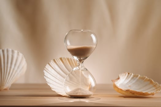 Elegant Hourglass and Seashells in a Minimalist Home Decor Composition photo