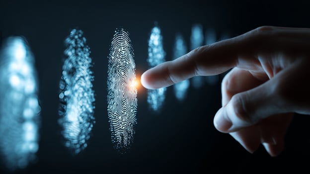 A close-up view reveals a hand pressing against a series of illuminated fingerprint patterns, showcasing the integration of biometric identification and modern security technology. photo
