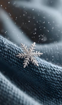 Delicate snowflake resting on warm knitted wool creating a cozy wintertime mood and highlighting the beauty of frozen photo