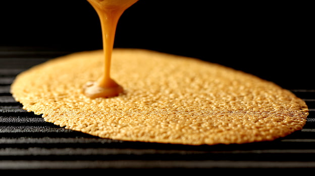 Caramel Sauce Pouring Onto Crispy Base Close Up. photo