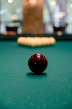 Billiards. Billiard balls on green table and white ball on the foreground photo